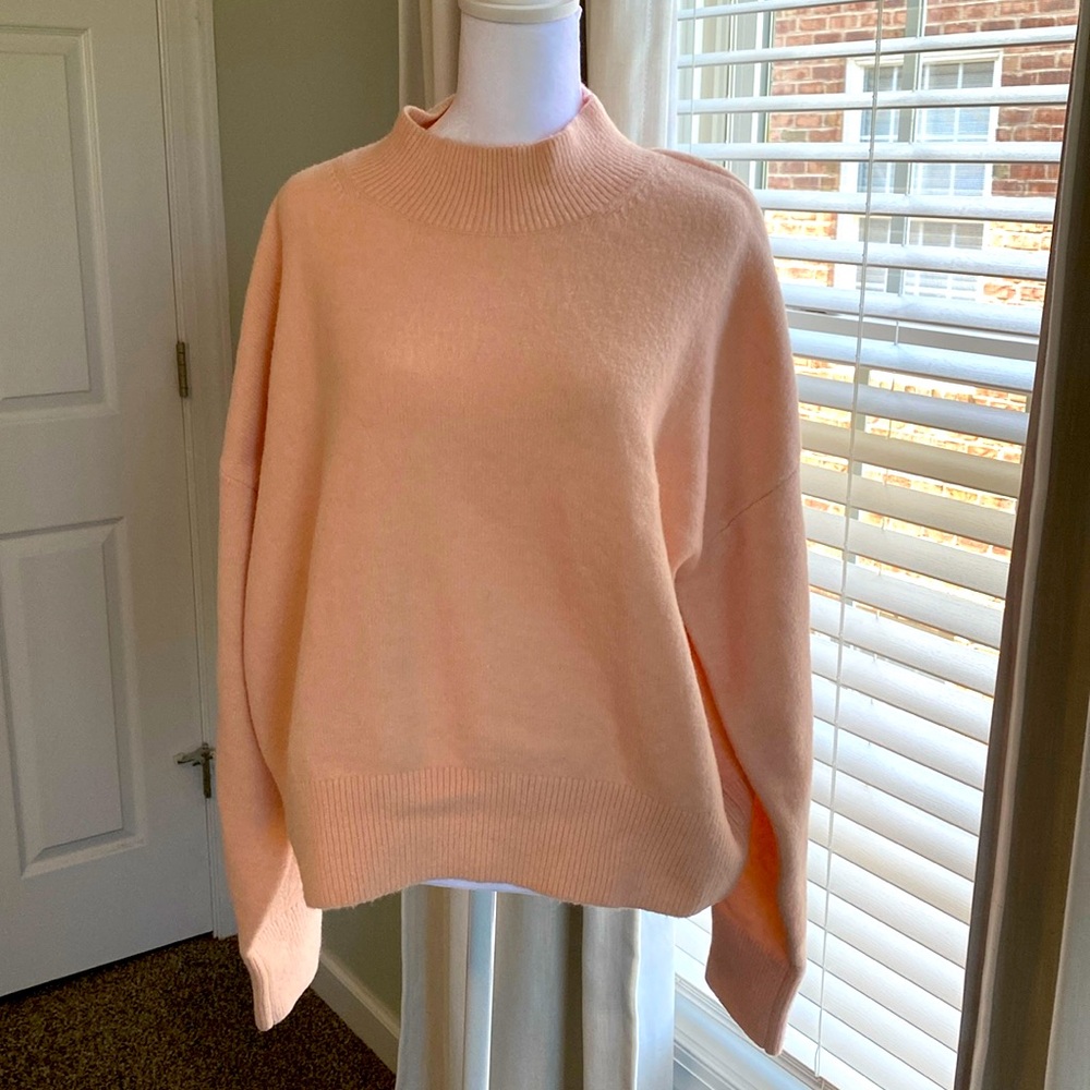 Cropped, boxy roll neck sweater in thick wool like recycled fabric.